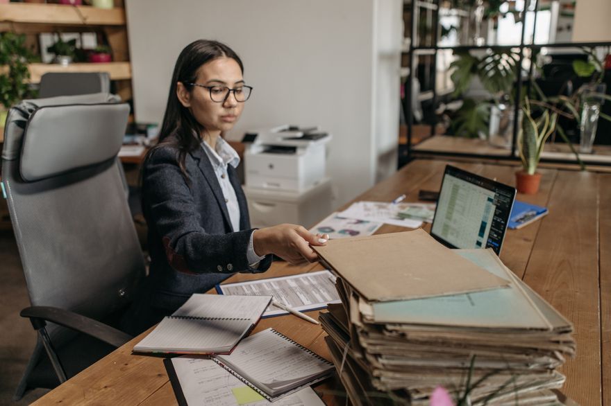 Coordinator reviewing quotation paperwork at an office desk