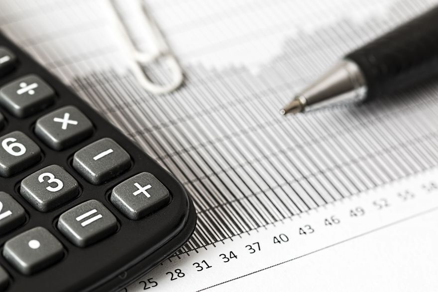Calculator and pen on a costing sheet — preparing supplier quotations